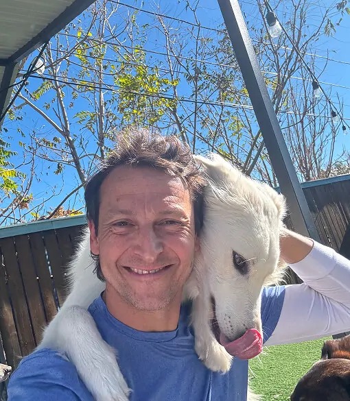 pet care specialist smiling with white dog